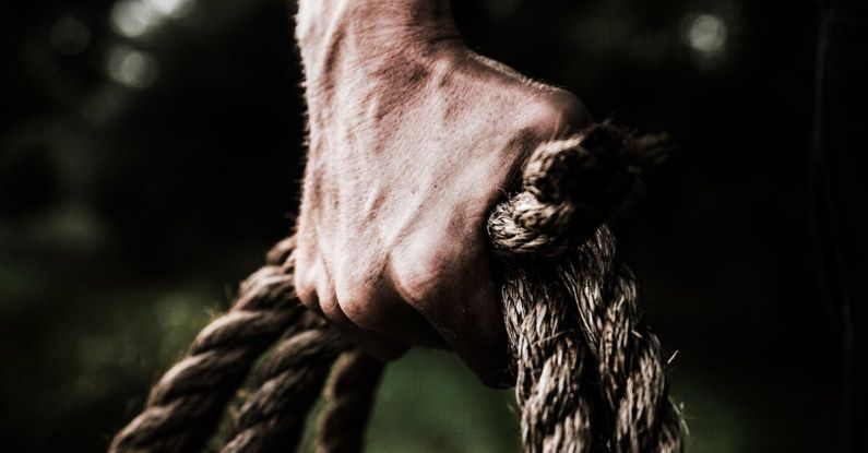 Strength - Man Holding Brown Rope