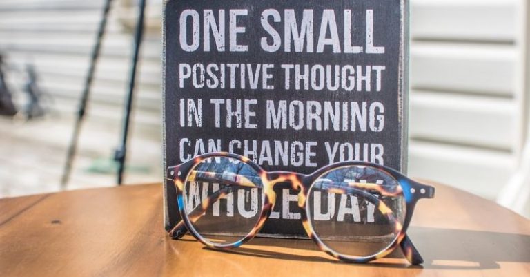 Thoughts - Photo of a Sign and Eyeglasses on Table